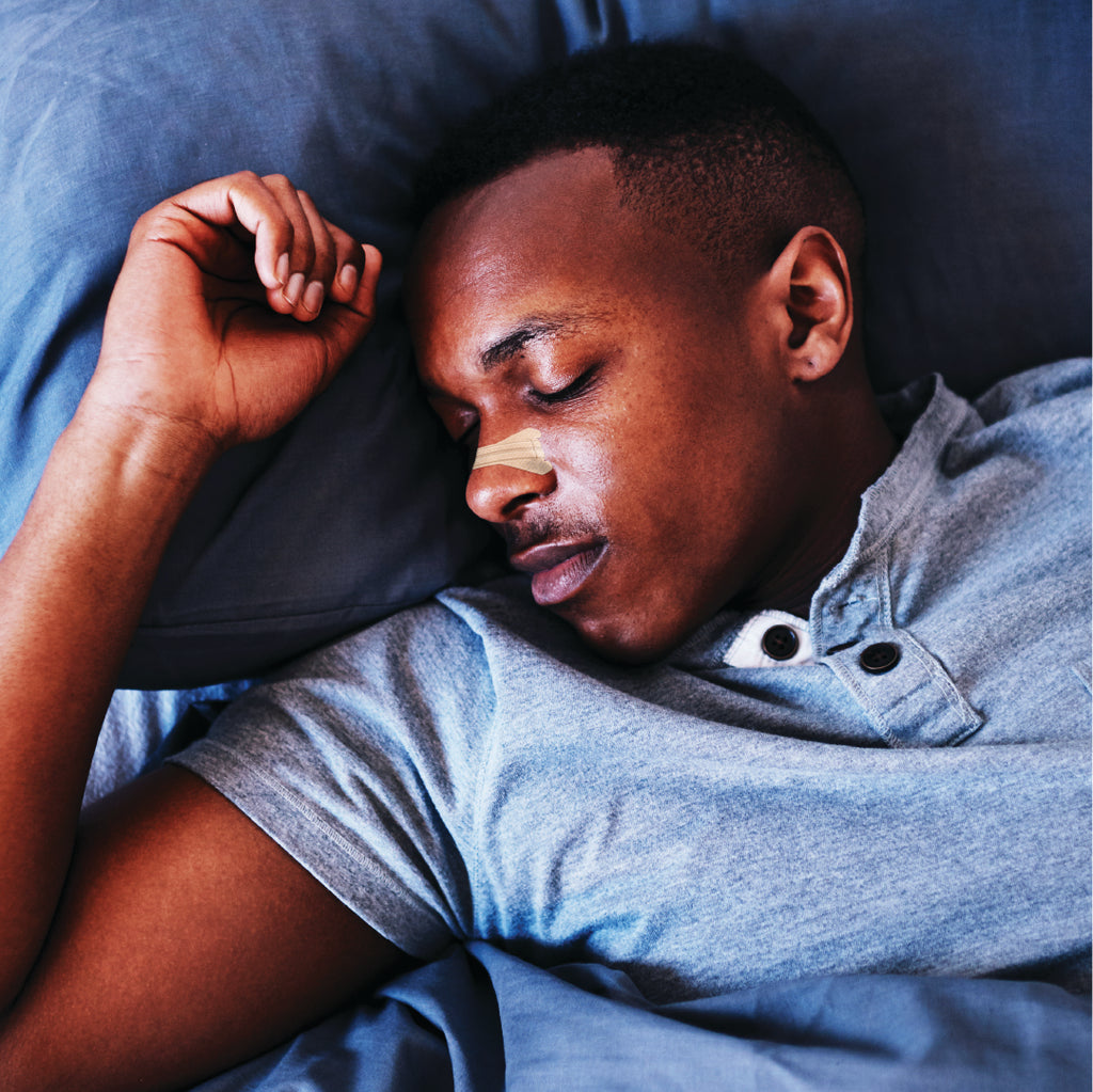 Man having a good nights sleep while wearing a clear passage nasal strip